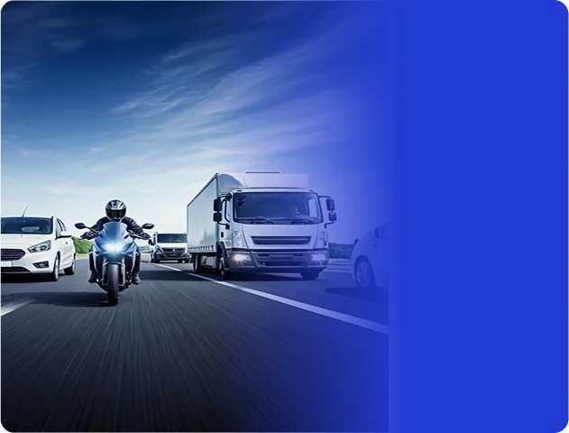 Motociclista em estrada entre carro branco e caminhão