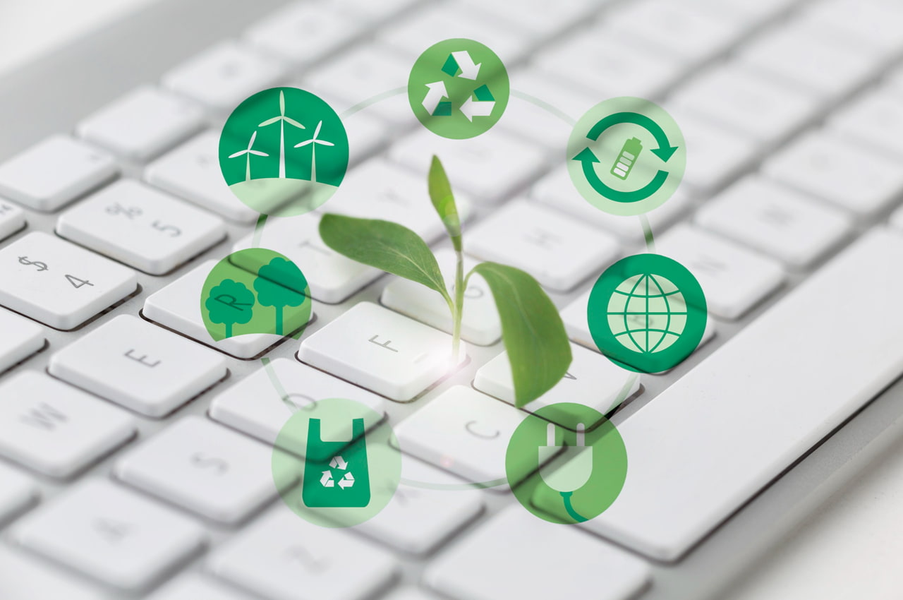 Teclado com broto e ícones verdes, ilustrando inovação e sustentabilidade digital.